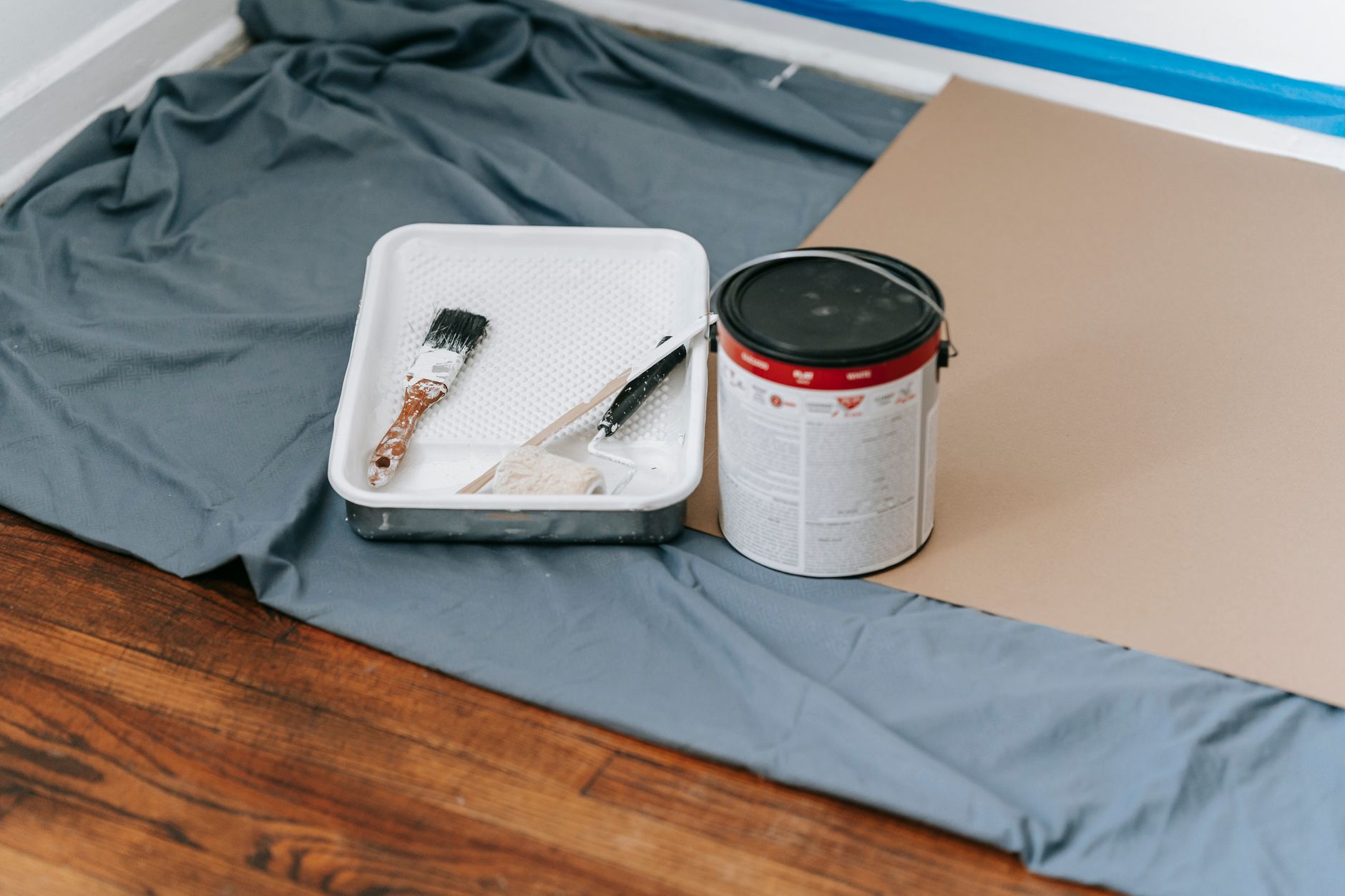 A collection of painting tools and materials prepared for a home renovation project indoors in Long Beach, CA